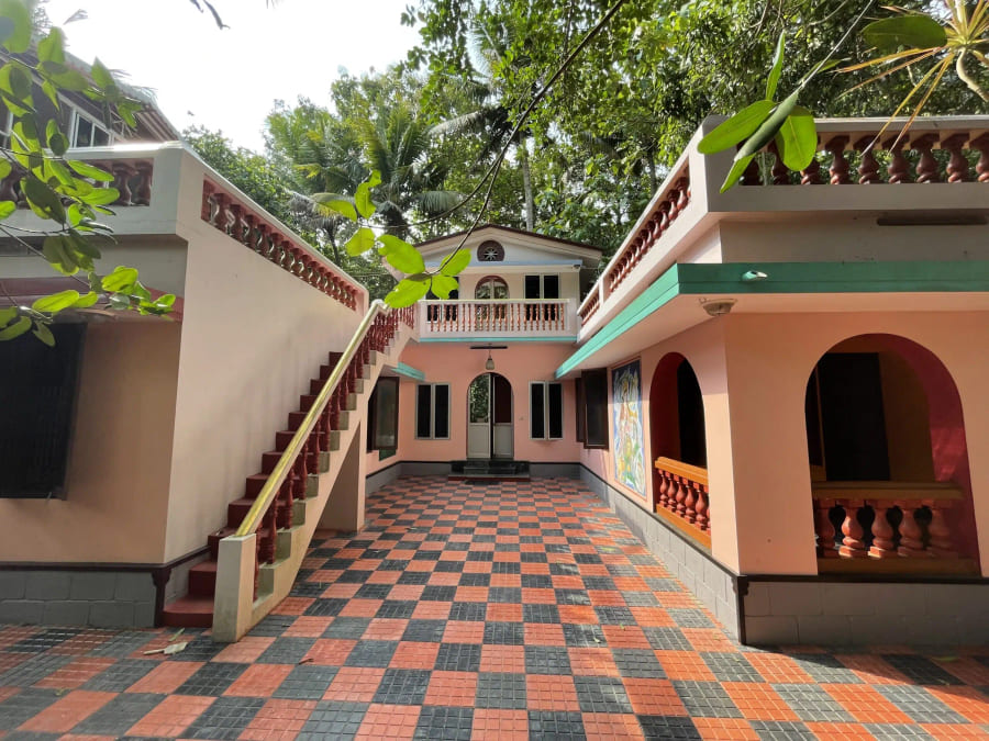 Guest accommodation block with an external stairway above the tiled courtyard