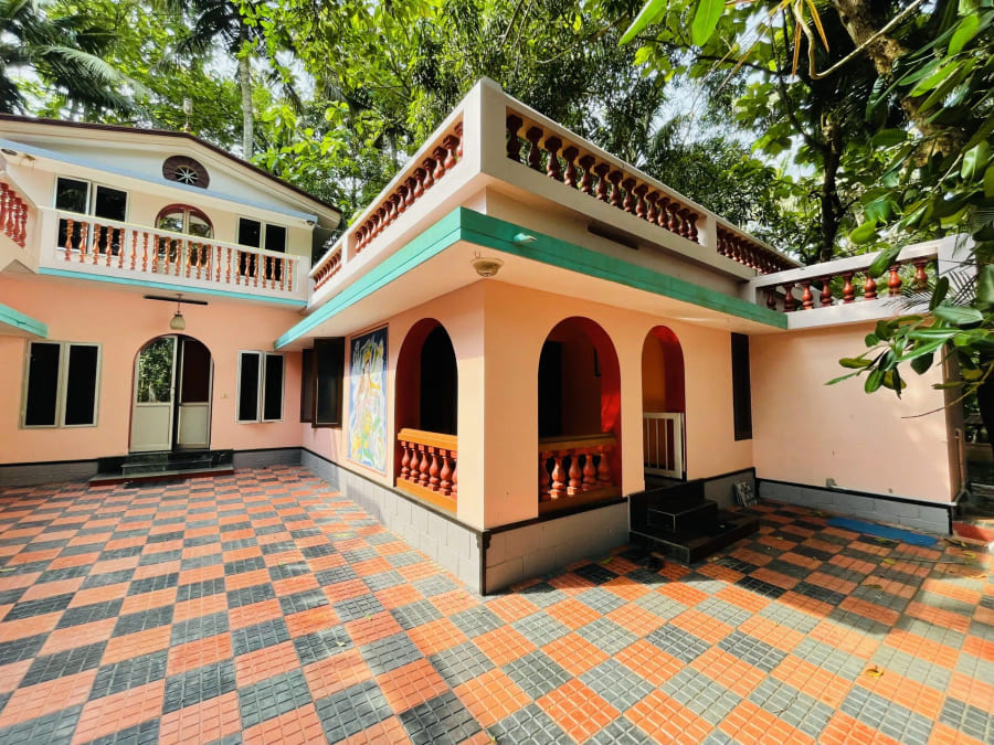 Arched verandah of the guest rooms seen across the courtyard