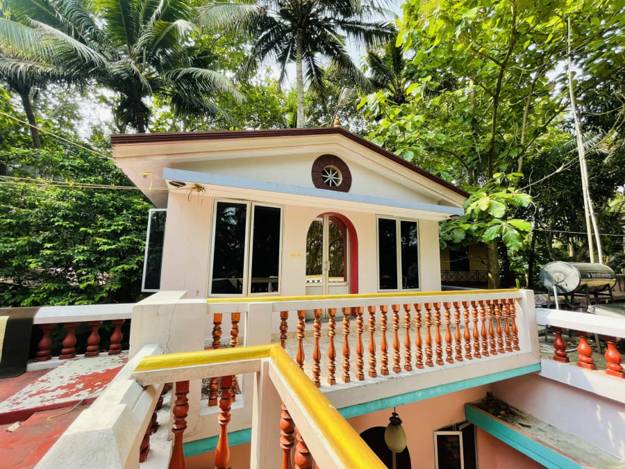 Balcony and tiled roof of a guest cottage among the palms