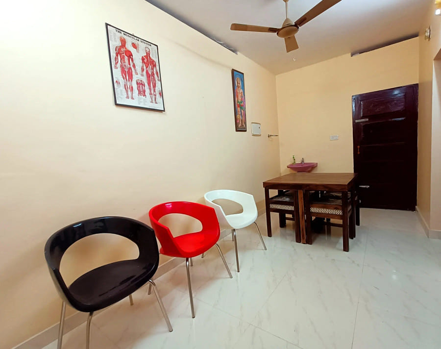Consulting room with an anatomical chart and seating for visitors