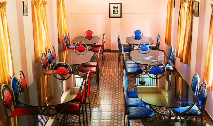 The ashram dining hall set with tables and chairs