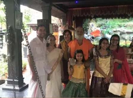 The Guru with his family gathered outside the temple