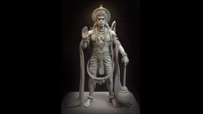 The large stone idol of Hanuman in the ashram garden, one hand open in a gesture of blessing