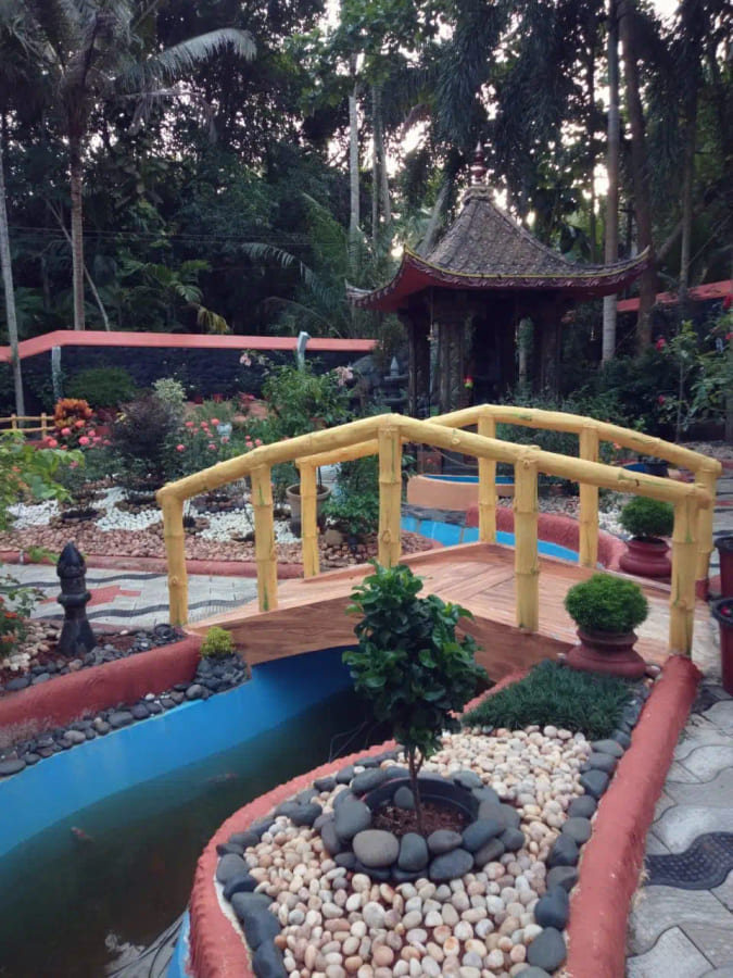 Timber footbridge crossing the water channel in the garden