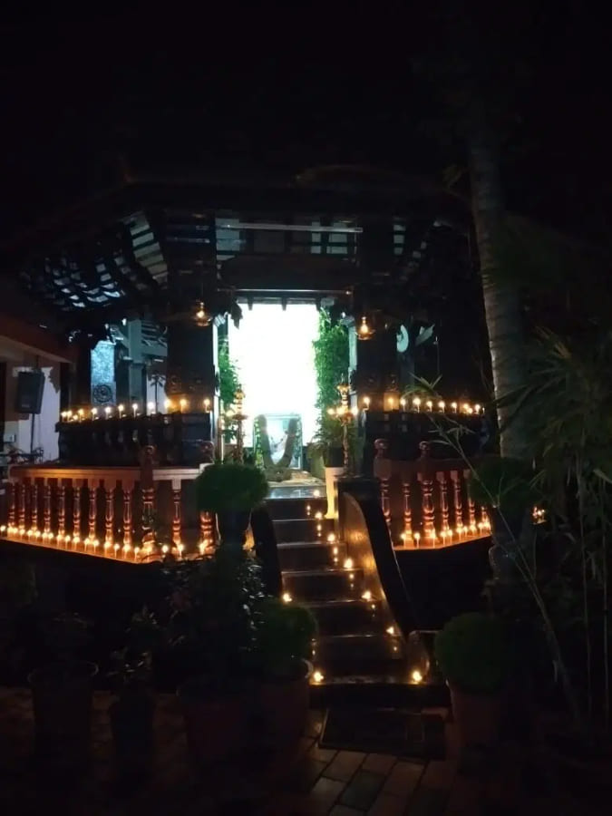 Rows of lamps burning along the temple walkway