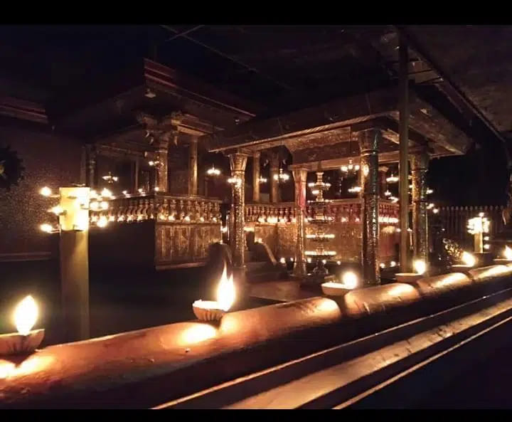Oil lamps set along the temple&rsquo;s timber balustrade