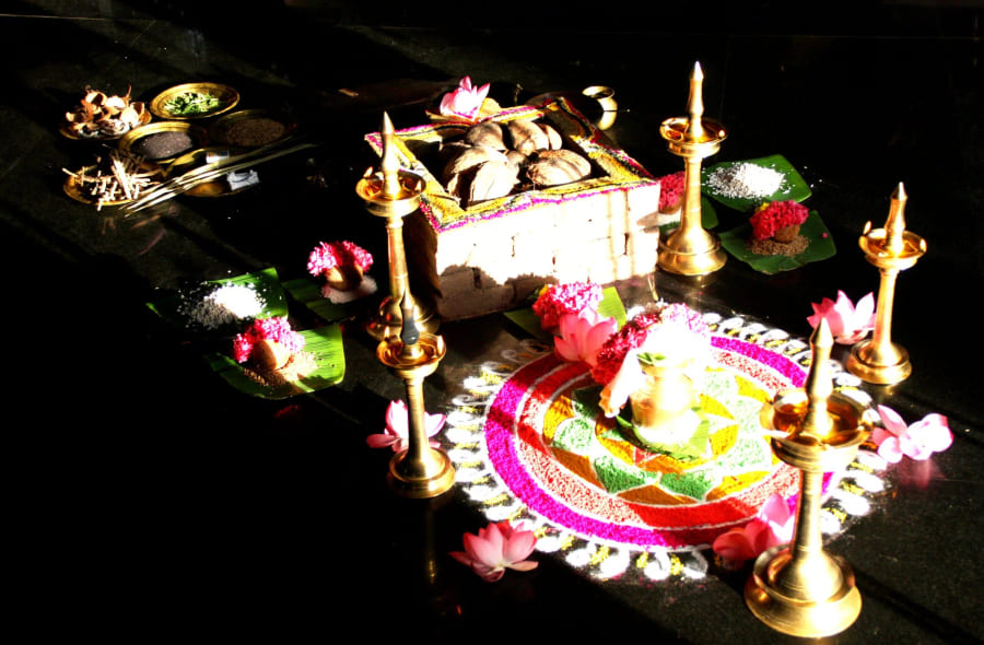 Lamps, flowers and offerings laid out for a pooja
