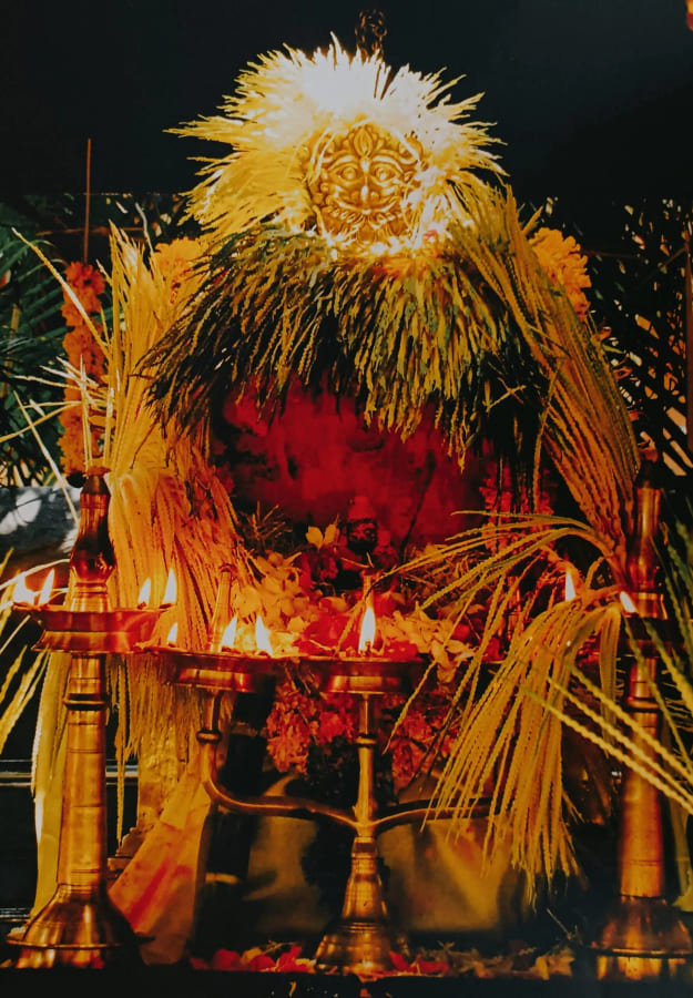 The shrine dressed with sheaves of grain for a harvest celebration