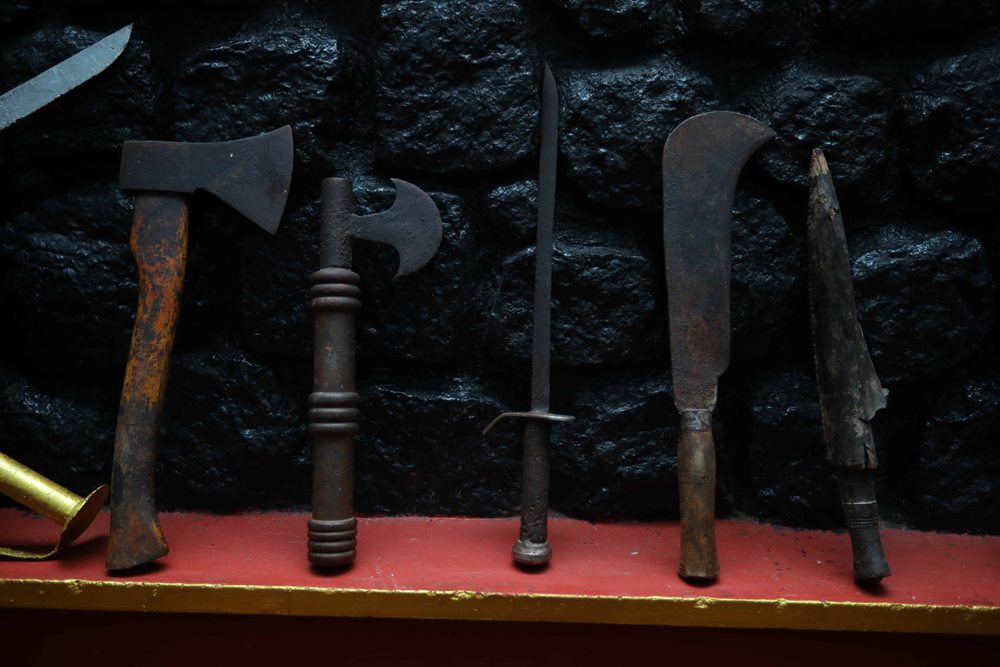Axe, sword and blade resting on the weapons shelf of the Kalari