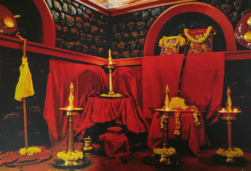 The poothara shrine of the Kalari with lamps, flowers and offerings