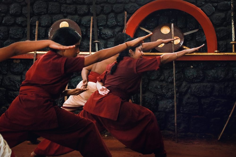Paired hand movements practised side by side along the Kalari wall