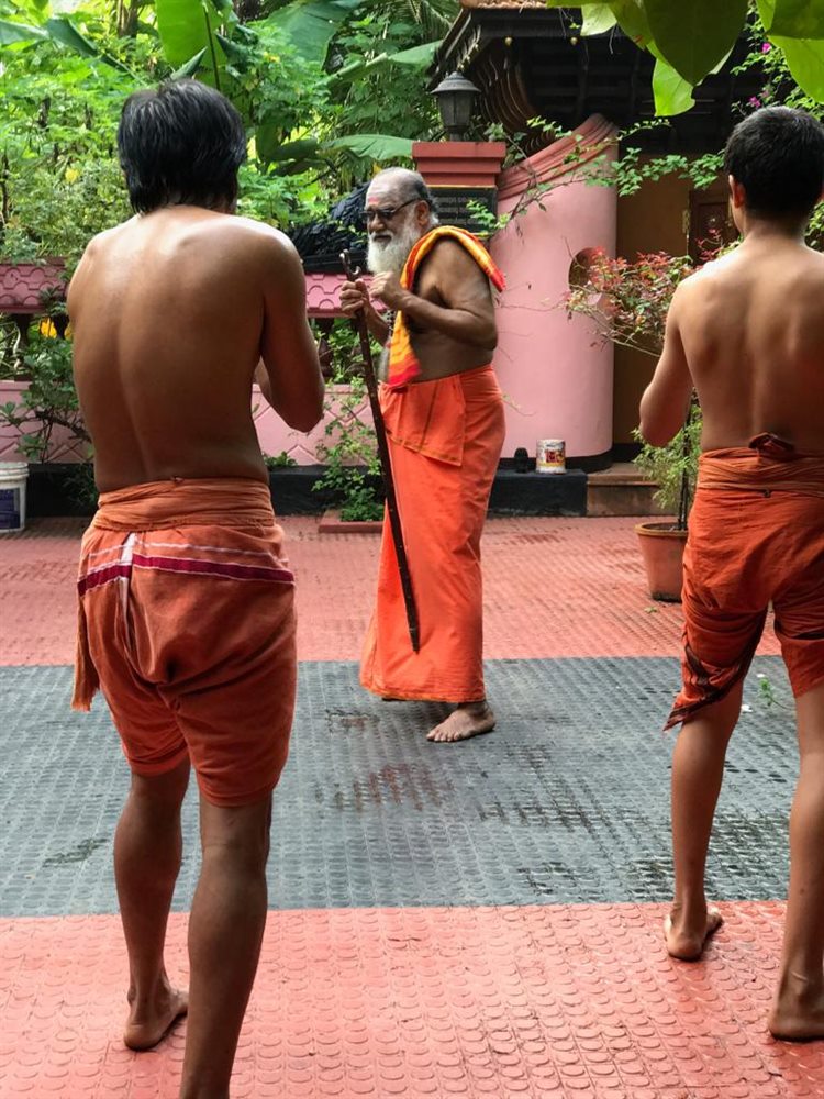 Students standing before Guruji at the start of a practice session